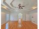 Large primary bedroom featuring trey ceilings, hardwood floors, and an arched doorway at 5780 Warren Farm Sw Rd, Powder Springs, GA 30127