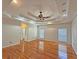 Bright primary bedroom with tray ceiling, recessed lighting, and hardwood floors at 5780 Warren Farm Sw Rd, Powder Springs, GA 30127