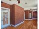 Sunroom with brick walls, hardwood floors and many large windows at 5780 Warren Farm Sw Rd, Powder Springs, GA 30127