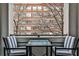 Cozy balcony featuring striped chairs, a glass table, and a stunning view of a brick building at 805 Peachtree Ne St # 317, Atlanta, GA 30308