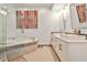 Luxurious bathroom featuring a soaking tub, double sink vanity with quartz counters, and modern lighting at 805 Peachtree Ne St # 317, Atlanta, GA 30308