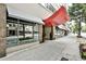 Modern building entrance featuring a sleek red awning and large glass windows at 805 Peachtree Ne St # 317, Atlanta, GA 30308