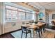 Bright dining room with a wooden table, gray chairs, and large windows offering a city view at 805 Peachtree Ne St # 317, Atlanta, GA 30308