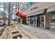 Street view featuring a local barbershop in a vibrant city neighborhood at 805 Peachtree Ne St # 317, Atlanta, GA 30308
