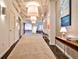 Long hallway with neutral carpet and striking paintings at 805 Peachtree Ne St # 317, Atlanta, GA 30308