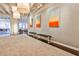 Hallway showcasing modern art, bench seating, and access to living areas at 805 Peachtree Ne St # 317, Atlanta, GA 30308