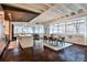 Spacious living room with exposed beams, hardwood floors, modern decor, and large windows providing lots of light at 805 Peachtree Ne St # 317, Atlanta, GA 30308