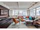 Inviting living room with modern furniture, exposed ceilings, and abundant natural light from large windows at 805 Peachtree Ne St # 317, Atlanta, GA 30308