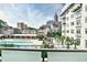 Community pool area with lounge chairs, lush landscaping, and city views in the background at 805 Peachtree Ne St # 317, Atlanta, GA 30308