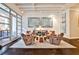 Comfortable sitting area featuring modern chairs, accent table, and access to outdoor space at 805 Peachtree Ne St # 317, Atlanta, GA 30308
