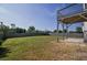 Spacious backyard with a mix of green grass and patchy spots, surrounded by a wooden fence at 907 Southfork Dr, Loganville, GA 30052