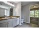 Bathroom featuring double sinks, granite countertops and modern fixtures at 907 Southfork Dr, Loganville, GA 30052
