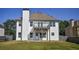Rear view of house featuring white siding, upper deck, and an open backyard at 907 Southfork Dr, Loganville, GA 30052