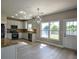Modern kitchen with stainless steel appliances, stylish backsplash, and granite countertops at 907 Southfork Dr, Loganville, GA 30052