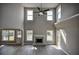 Bright living room featuring a fireplace, high ceilings, and abundant natural light at 907 Southfork Dr, Loganville, GA 30052