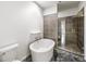 Well-lit bathroom featuring a modern bathtub, a gray-tiled accent wall, and a glass-enclosed shower at 130 Arizona Ne Ave # 106, Atlanta, GA 30307