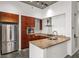 Modern kitchen with stainless steel appliances, granite countertops, and dark wood cabinets at 130 Arizona Ne Ave # 106, Atlanta, GA 30307
