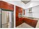 Well-lit kitchen with stainless steel refrigerator and granite countertops at 130 Arizona Ne Ave # 106, Atlanta, GA 30307