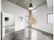 Open-concept living room with concrete floor and large windows at 130 Arizona Ne Ave # 106, Atlanta, GA 30307