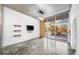 Bright living room featuring an open balcony with a view, shelves, and polished concrete floors at 130 Arizona Ne Ave # 106, Atlanta, GA 30307