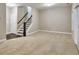 Spacious living room with plush carpeting and staircase leading to the upper level at 1912 Townsend Ne Ct, Atlanta, GA 30329