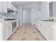 Bright kitchen with white cabinets, updated appliances, and decorative floors at 2660 Burnstone Run, Lawrenceville, GA 30044