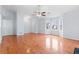 Large living room featuring hardwood floors, white walls, a ceiling fan, and a multitude of windows at 2660 Burnstone Run, Lawrenceville, GA 30044