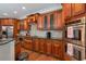 This kitchen features wood cabinets, stainless steel appliances, and stone countertops at 726 Fraser Ct, Mcdonough, GA 30253