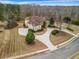 Aerial view of a beautiful home with manicured lawns in an upscale residential neighborhood at 1069 Eagles Brooke Dr, Locust Grove, GA 30248