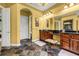 Bathroom showcasing tile floors, double vanity, framed mirror, and natural lighting at 1069 Eagles Brooke Dr, Locust Grove, GA 30248