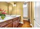 Bathroom featuring vanity with bowl sink, hardwood floors and stylish decor at 1069 Eagles Brooke Dr, Locust Grove, GA 30248