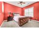 Bedroom with a large window, bed, end table, carpet, and a ceiling fan at 1069 Eagles Brooke Dr, Locust Grove, GA 30248