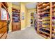 Walk-in closet featuring custom built-in shelves, cabinets, and drawers at 1069 Eagles Brooke Dr, Locust Grove, GA 30248