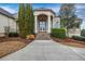 Front entrance of home featuring a stone-laid stoop and an arched front door at 1069 Eagles Brooke Dr, Locust Grove, GA 30248