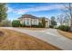 Charming home with a curved driveway, well-maintained landscaping, and traditional architecture at 1069 Eagles Brooke Dr, Locust Grove, GA 30248