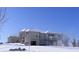 View of the rear of home covered in snow with covered porch and two-car garage at 1069 Eagles Brooke Dr, Locust Grove, GA 30248