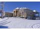 View of the side and front of a stucco home covered in snow with covered porch at 1069 Eagles Brooke Dr, Locust Grove, GA 30248