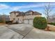 Rear view of an estate home showcasing three garage spaces and concrete driveway at 1069 Eagles Brooke Dr, Locust Grove, GA 30248