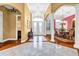 Spacious foyer featuring marble tile, hardwood floors, elegant columns, and a chandelier at 1069 Eagles Brooke Dr, Locust Grove, GA 30248