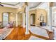 Open foyer with hardwood floors, columns, elegant furnishings and view to the entry at 1069 Eagles Brooke Dr, Locust Grove, GA 30248