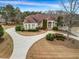 Stunning home featuring a circular driveway, manicured landscaping, and an elegant entrance at 1069 Eagles Brooke Dr, Locust Grove, GA 30248