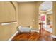 Hallway with hardwood floors and neutral walls, leading into a formal dining room at 1069 Eagles Brooke Dr, Locust Grove, GA 30248