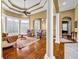 Spacious living room featuring columns, hardwood floors, and natural light at 1069 Eagles Brooke Dr, Locust Grove, GA 30248