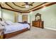 Main bedroom featuring a decorative ceiling, dresser, and doors leading to other rooms at 1069 Eagles Brooke Dr, Locust Grove, GA 30248