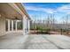 A look at the covered patio with decorative columns and backyard at 1069 Eagles Brooke Dr, Locust Grove, GA 30248