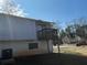 View of a home's siding and a deck with wood railings from the back yard at 1454 Walnut Log Pl, Austell, GA 30168