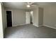 Cozy bedroom featuring neutral walls, carpeted floor, a ceiling fan, and a closet, offering a comfortable retreat at 1454 Walnut Log Pl, Austell, GA 30168