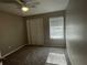 Comfortable bedroom with a ceiling fan, large window, and closet at 1454 Walnut Log Pl, Austell, GA 30168