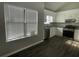 Bright kitchen featuring white cabinets, stainless steel appliances, granite counters, and wood look floors at 1454 Walnut Log Pl, Austell, GA 30168