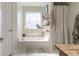 Bright bathroom showcasing a soaking tub with decorative shelving at 151 Berkshire Dr, Hiram, GA 30141